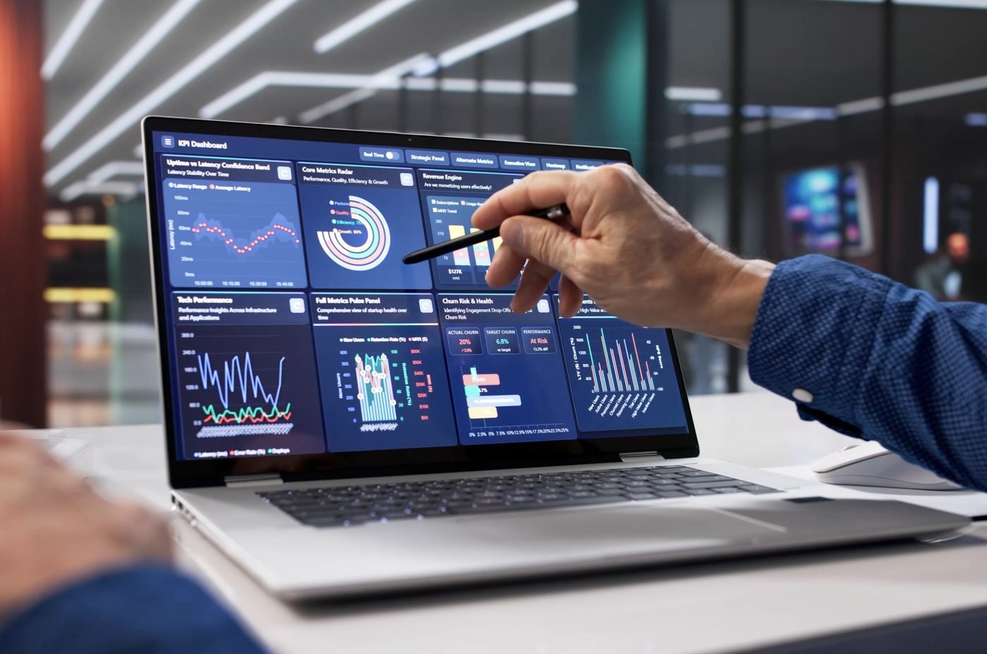 Reviewing a KPI dashboard on a laptop with a stylus